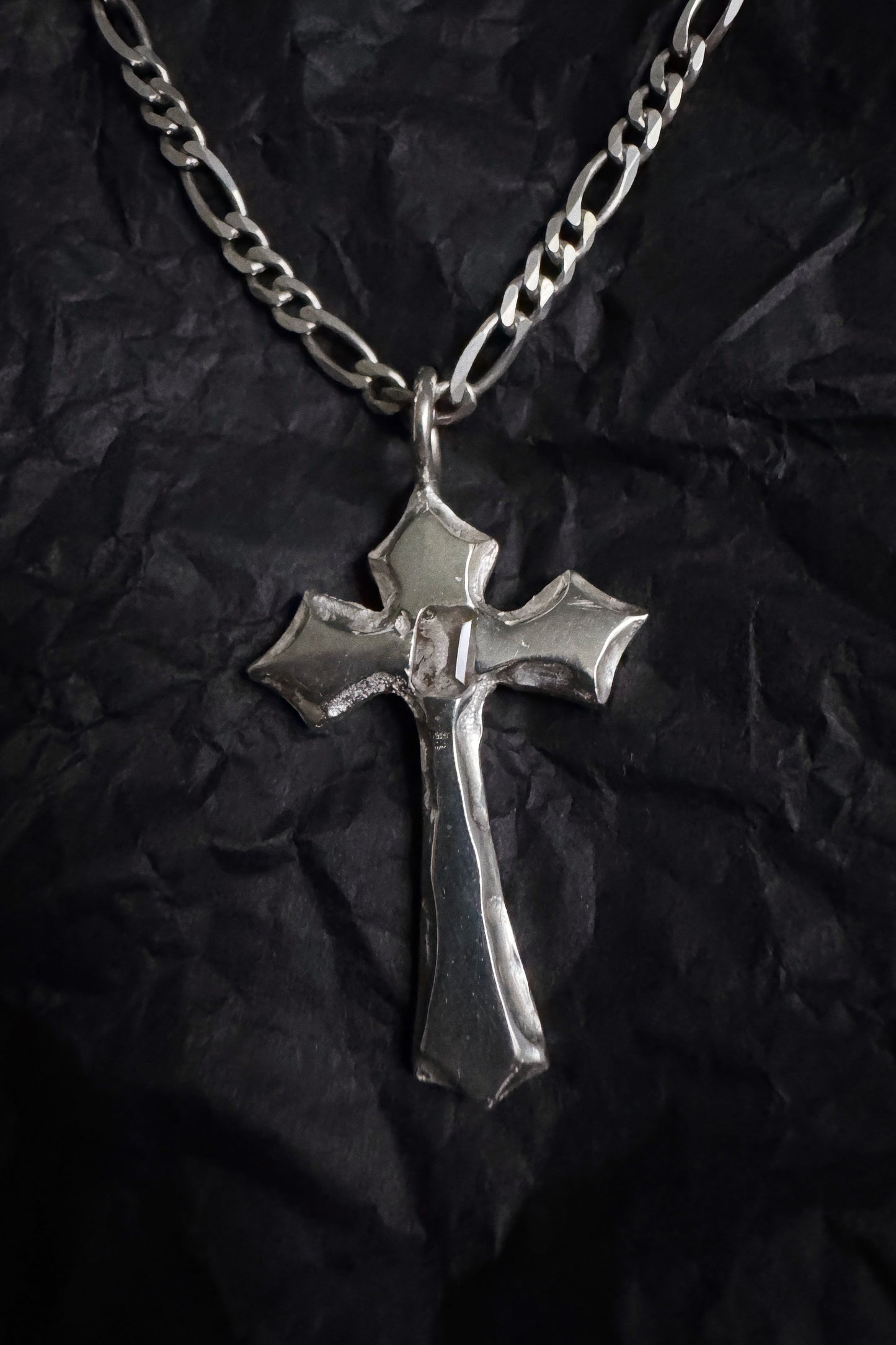 melted cross pendant