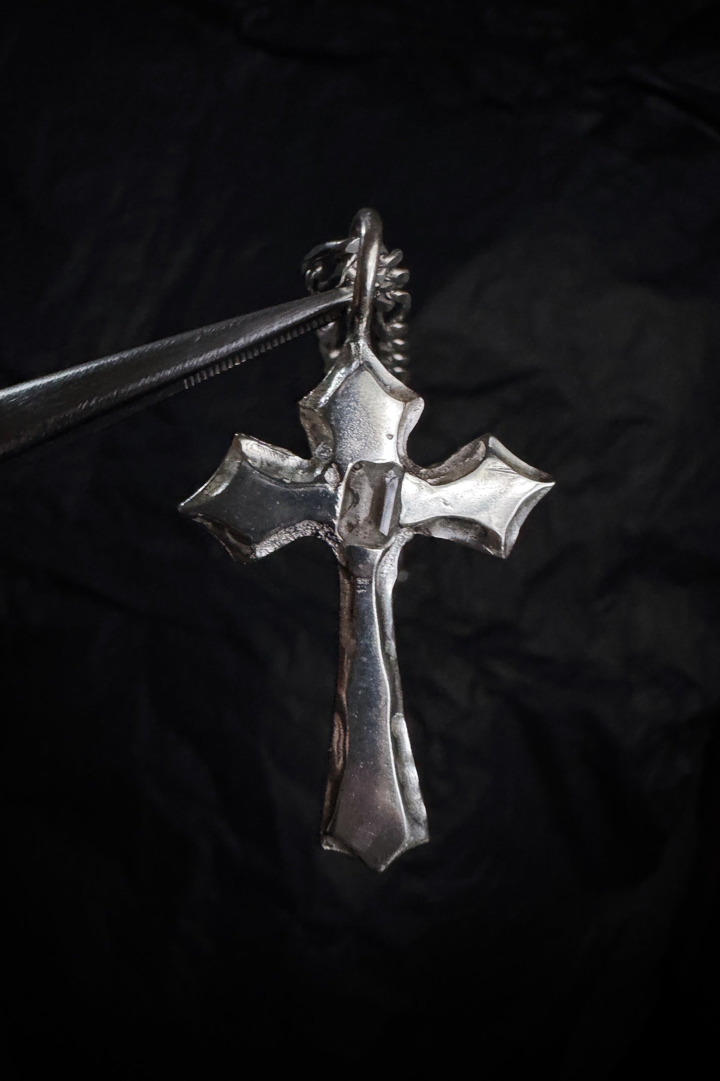 melted cross pendant